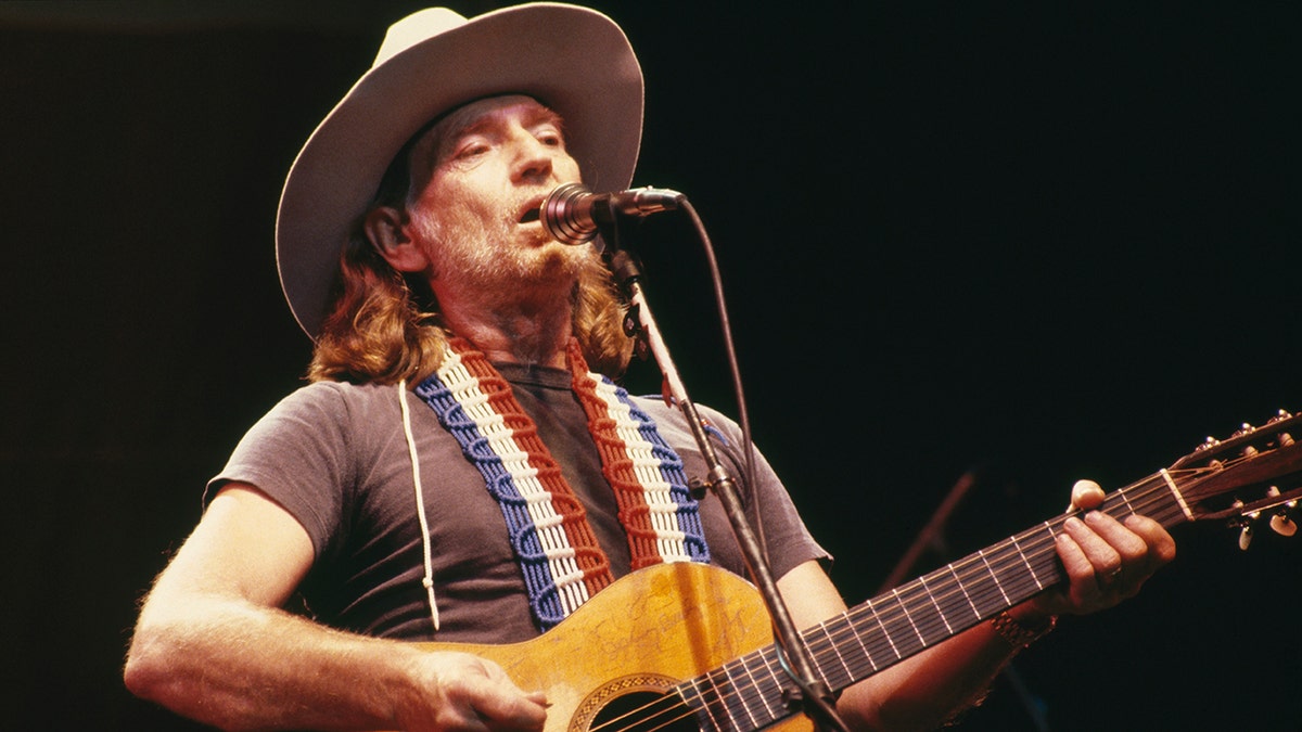 Willie Nelson performing on stage