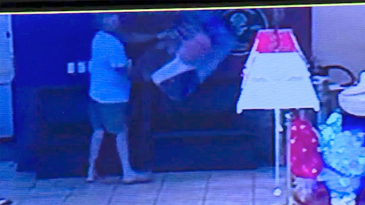 Surveillance video of man with DeSantis photo in bar