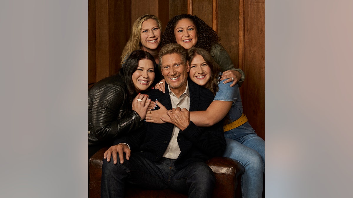 Gerry Turner is hugged by his two granddaughters and daughters in a family photo