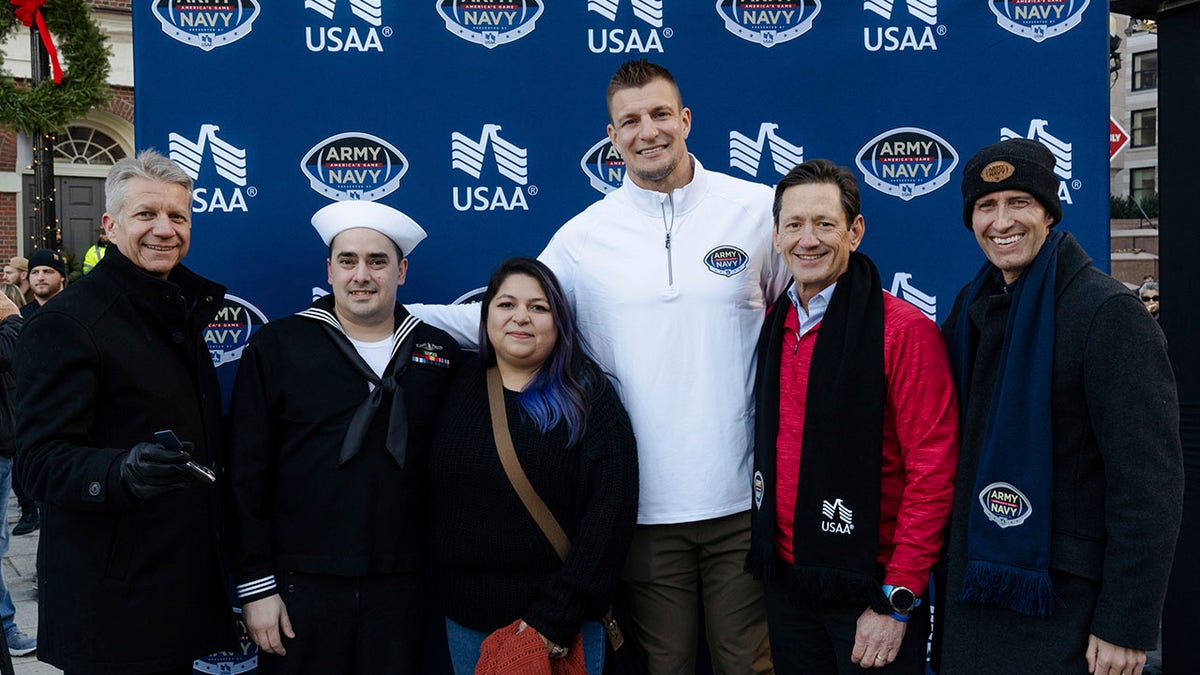 NFL legend Rob Gronkowski and USAA executives pose with members of the Kohlgraf family