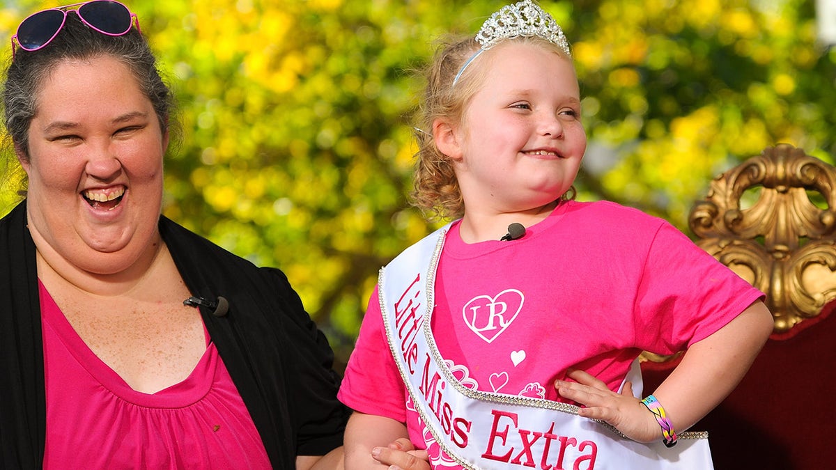 Honey Boo Boo wears a tiara next to her mom Mama June