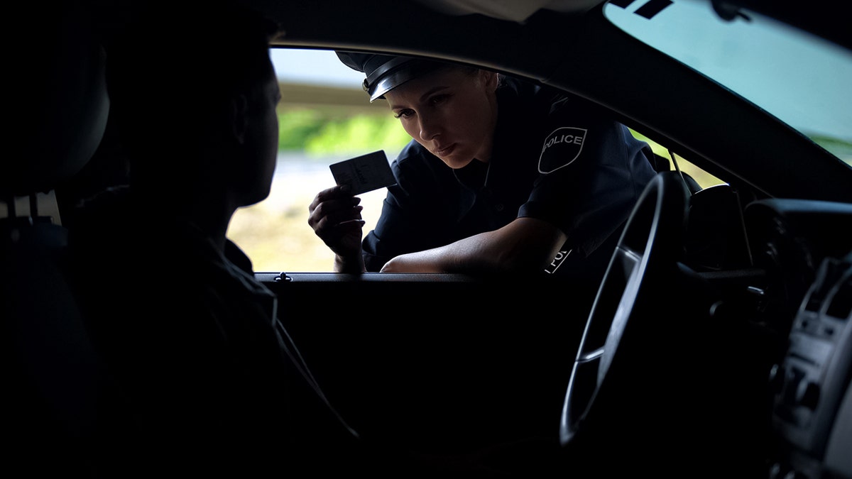 Police officer speaking with a driver