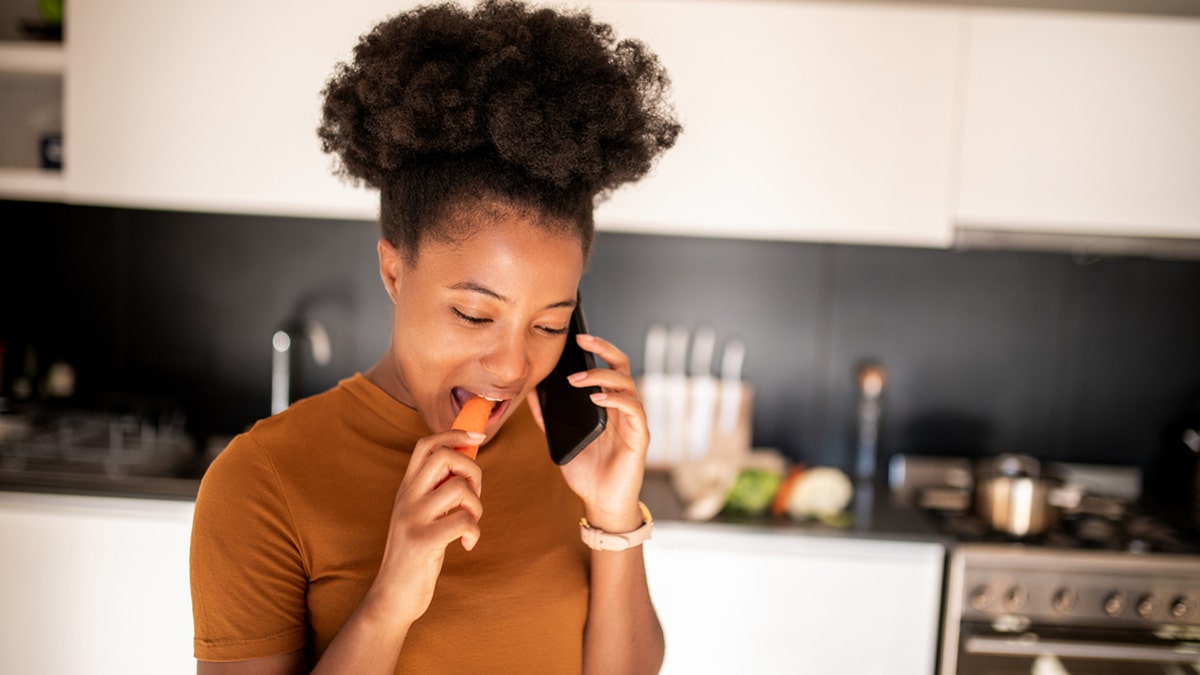 woman eating a carrot
