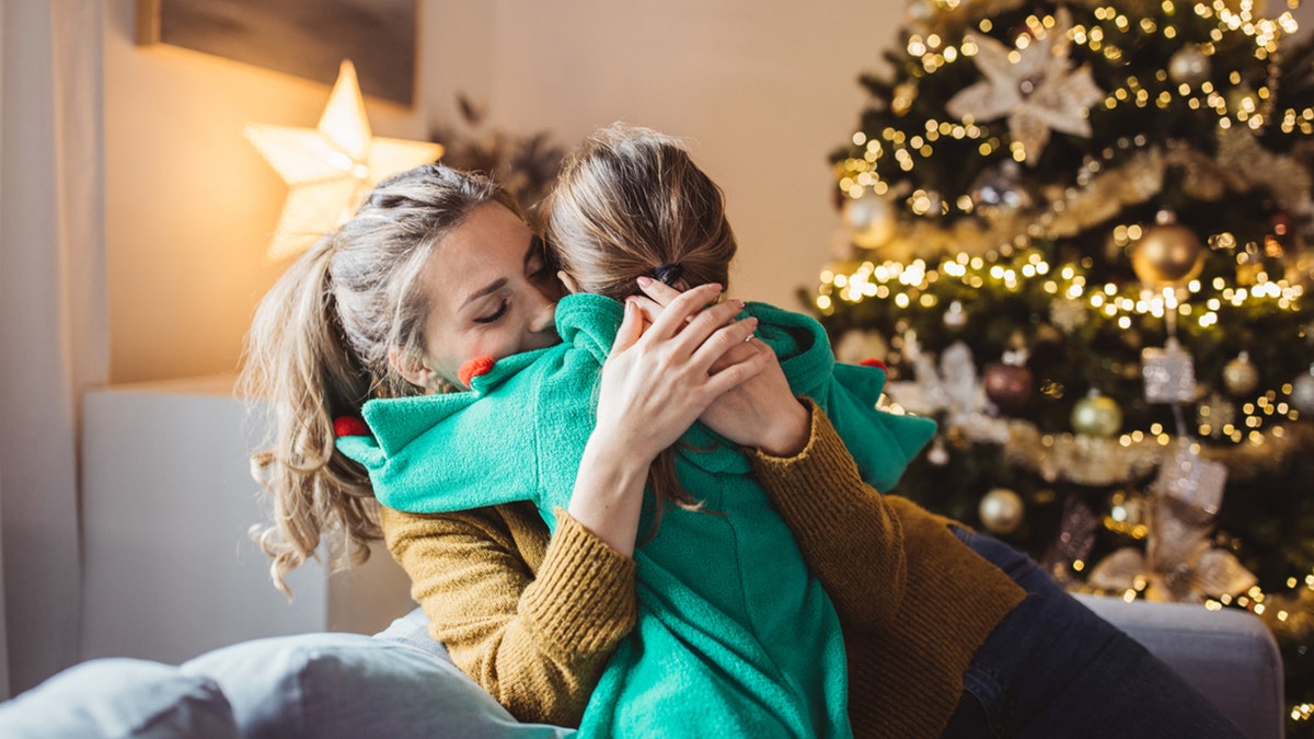 mama abraza a su hija en navidad