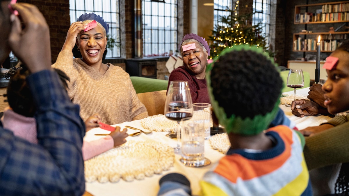 family plays game at christmas