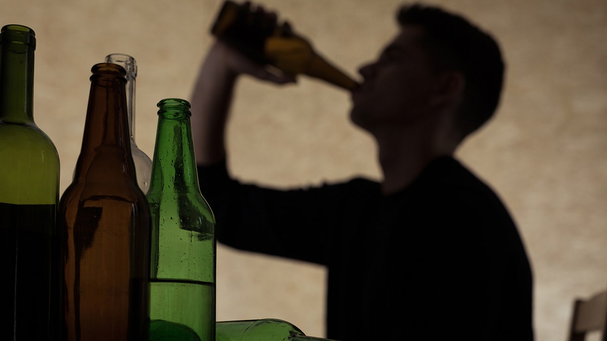 man drinks from a bottle