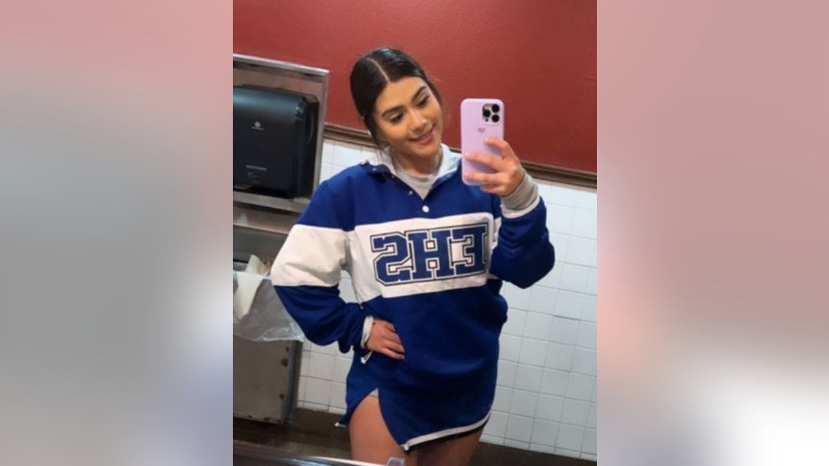 Liz Medina in a cheerleading uniform