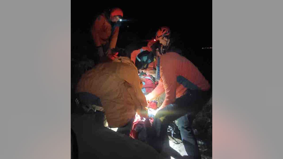 rescue teams helping injured hiker