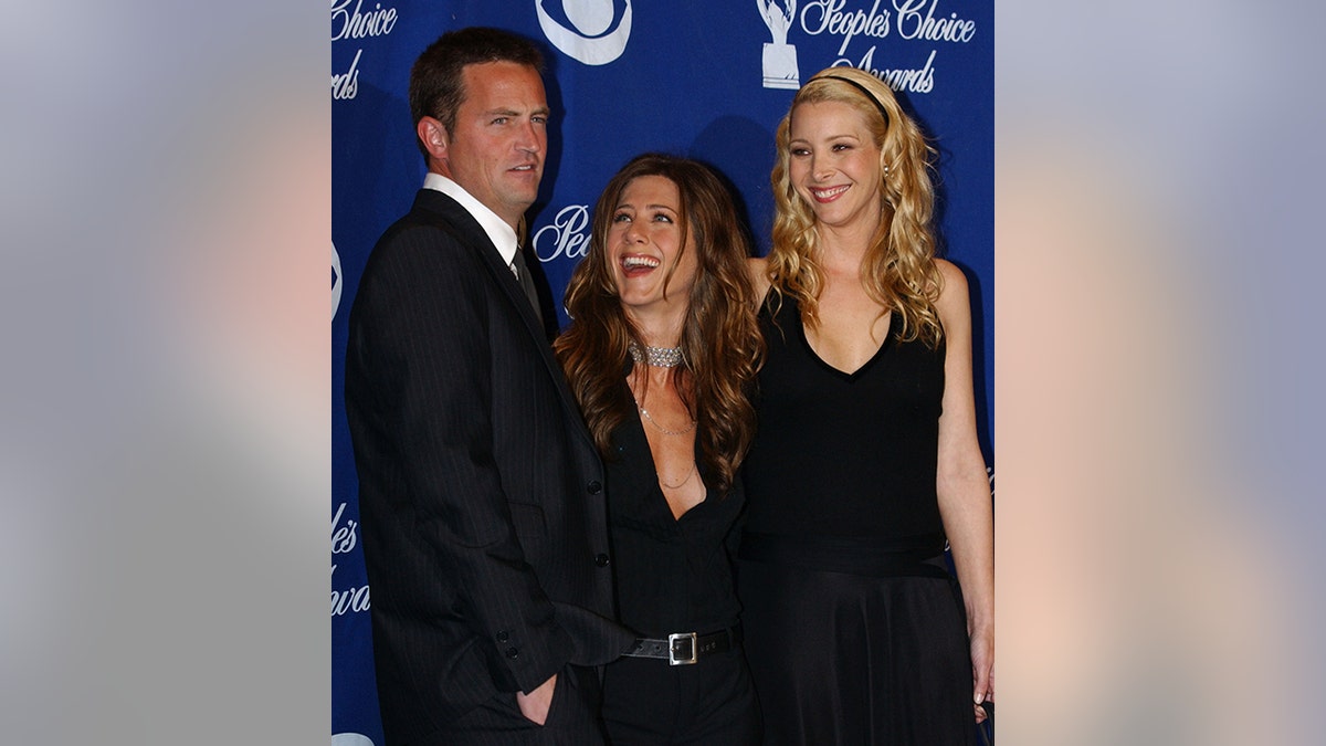 Jennifer Aniston in the middle looks up adoringly at Matthew Perry and is sandwiched between him and Lisa Kudrow