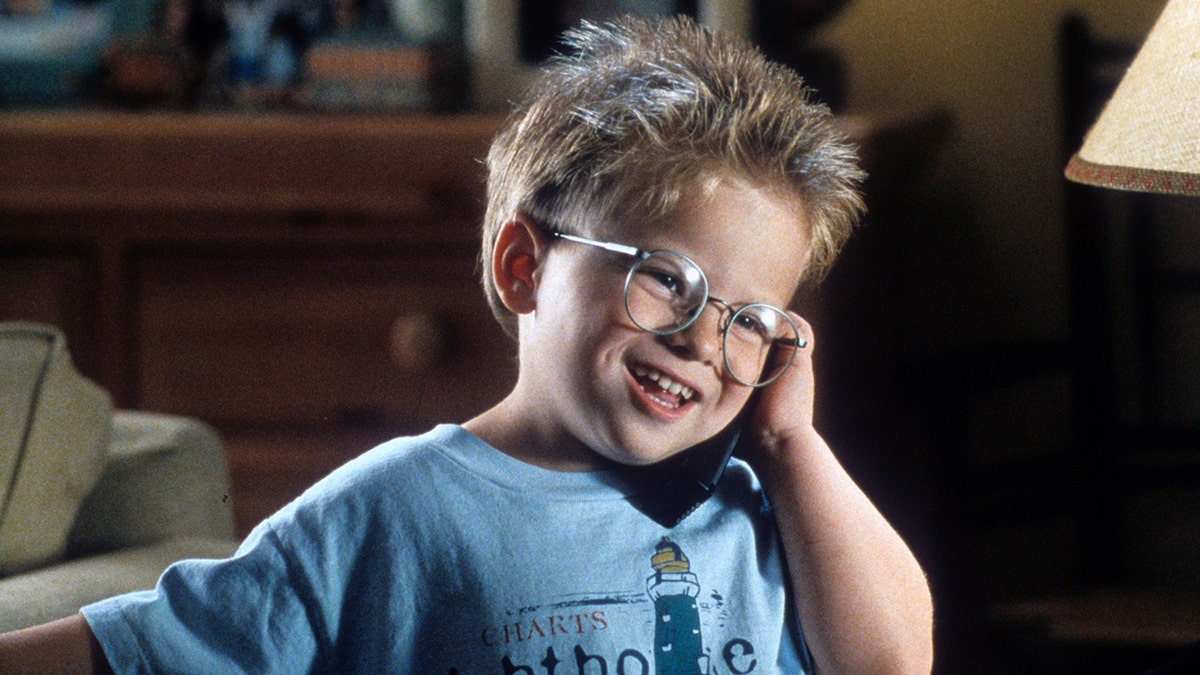 Jonathan Lipnicki in a blue shirt and glasses as Ray Boyd in "Jerry Maguire"