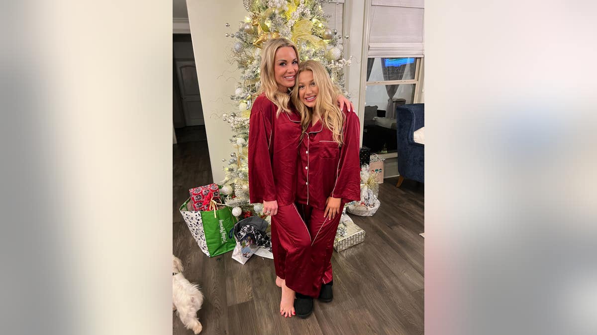 Ashley Baustert poses with her daughter Madison Brooks in matching pajamas for a past Christmas