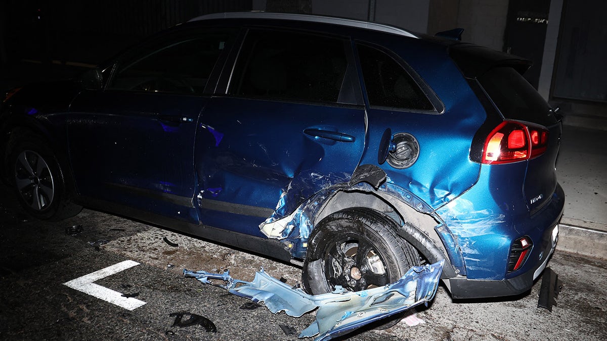 Blue Kia Niro SUV strewn about Sunset Boulevard following crash