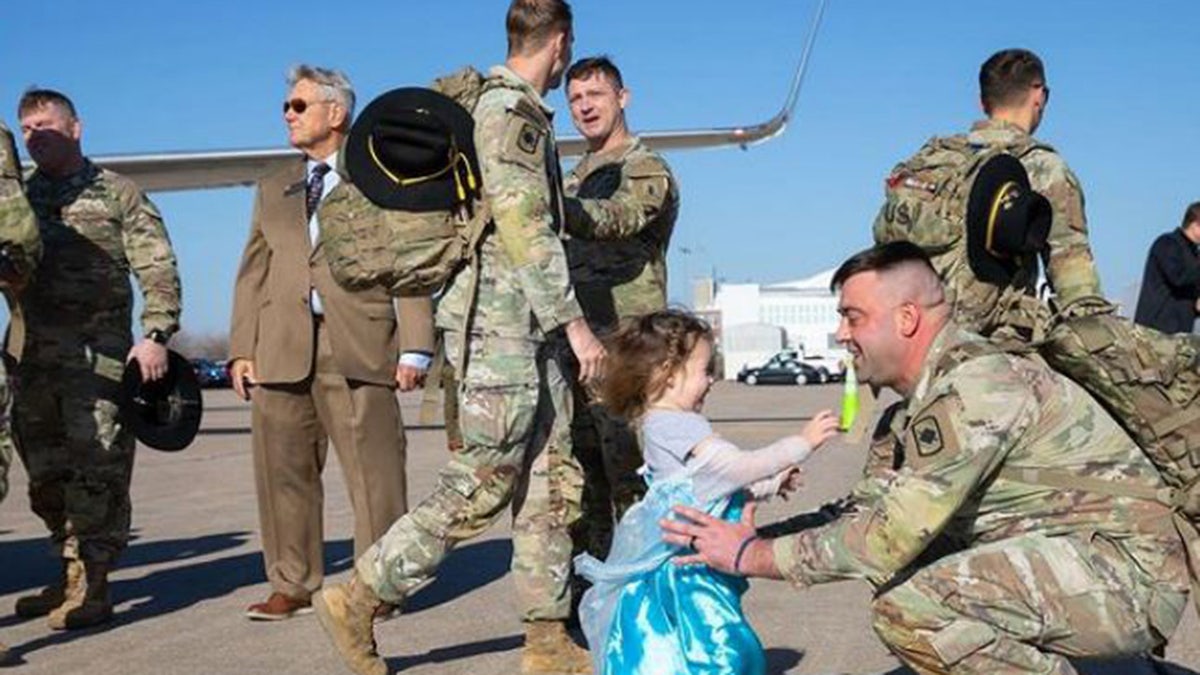 Woman jumps into Nebraska soldier s arms as troop returns from