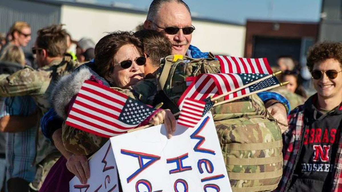 Woman jumps into Nebraska soldier s arms as troop returns from