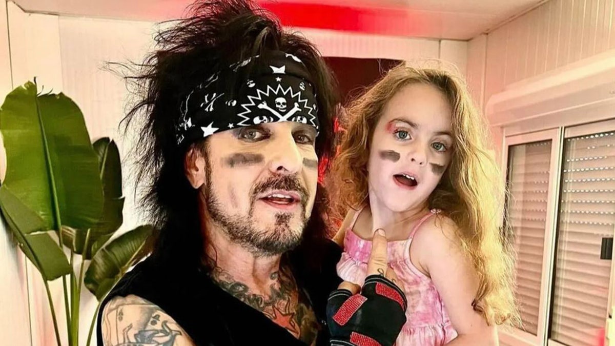 Nikki Sixx holding his 4-year-old daughter Ruby