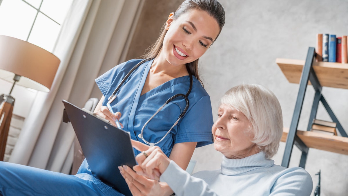 Older woman with nurse