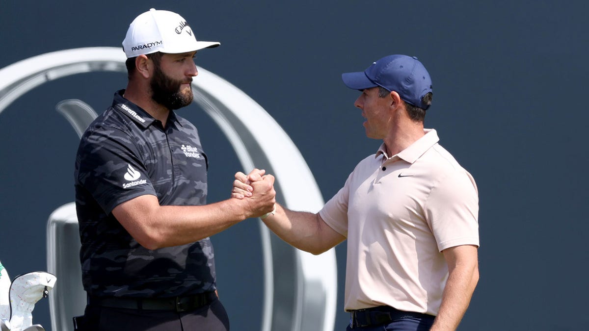Jon Rahm and Rory McIlroy high five