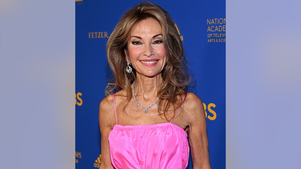 Susan Lucci in a pink dress smiles at the Daytime Emmy Awards