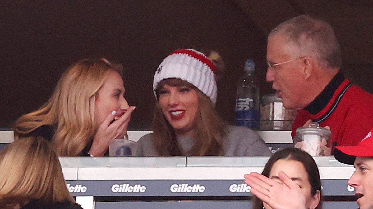 Taylor Swift gossips with Brittany Mahomes and her father Scott at the Kansas City Chiefs game at Gillette Stadium