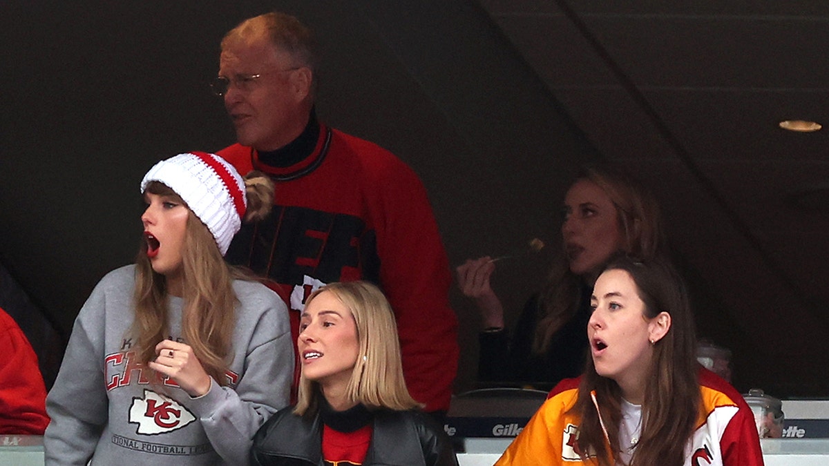 Taylor Swift looks animated during the Kansas City Chiefs Game against the New England Patriots with friends, her father and Brittany Mahomes in the suite