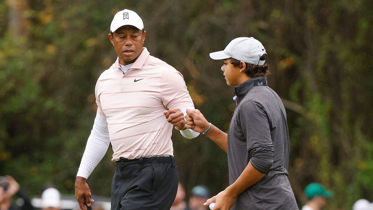 Tiger Woods’ son outdrives green, impresses dad with ‘f—ing nasty’ shot 2 Tiger and Charlie fist bump