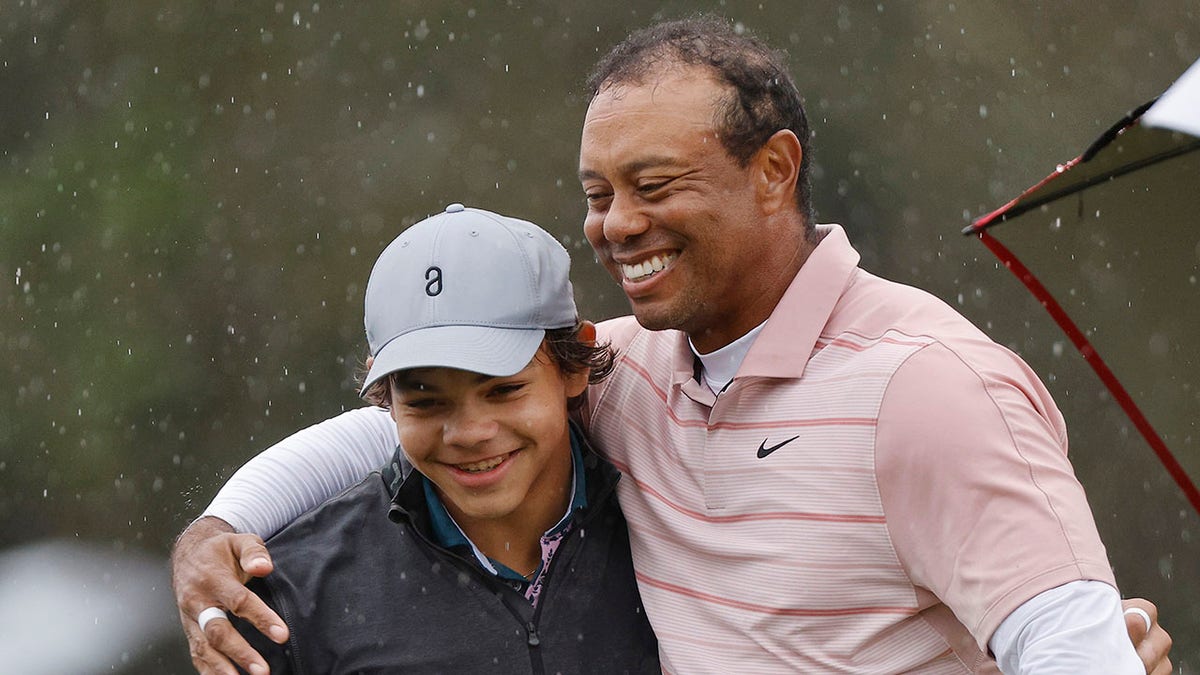 Tiger hugging his son
