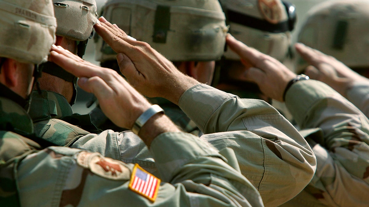US Army members saluting