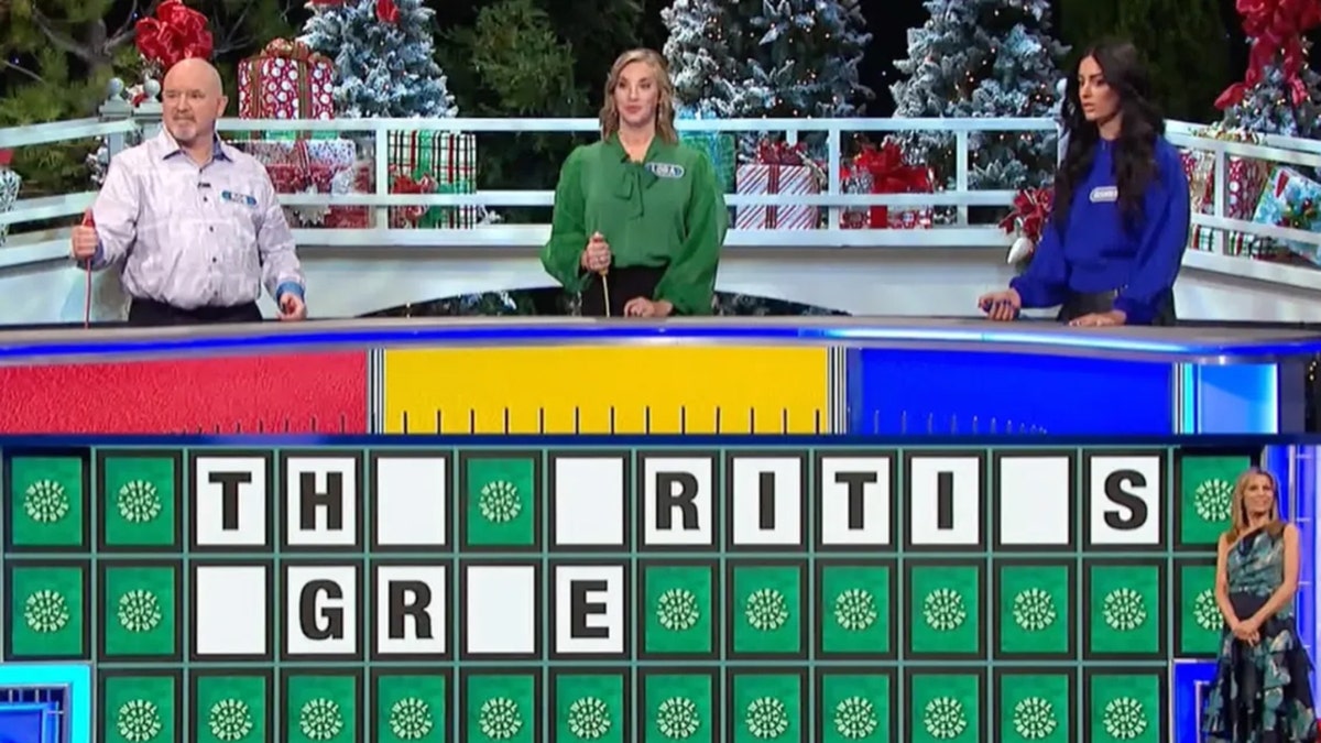 Screengrab of "Wheel of Fortune" with an unsolved puzzle and Vanna White in the corner