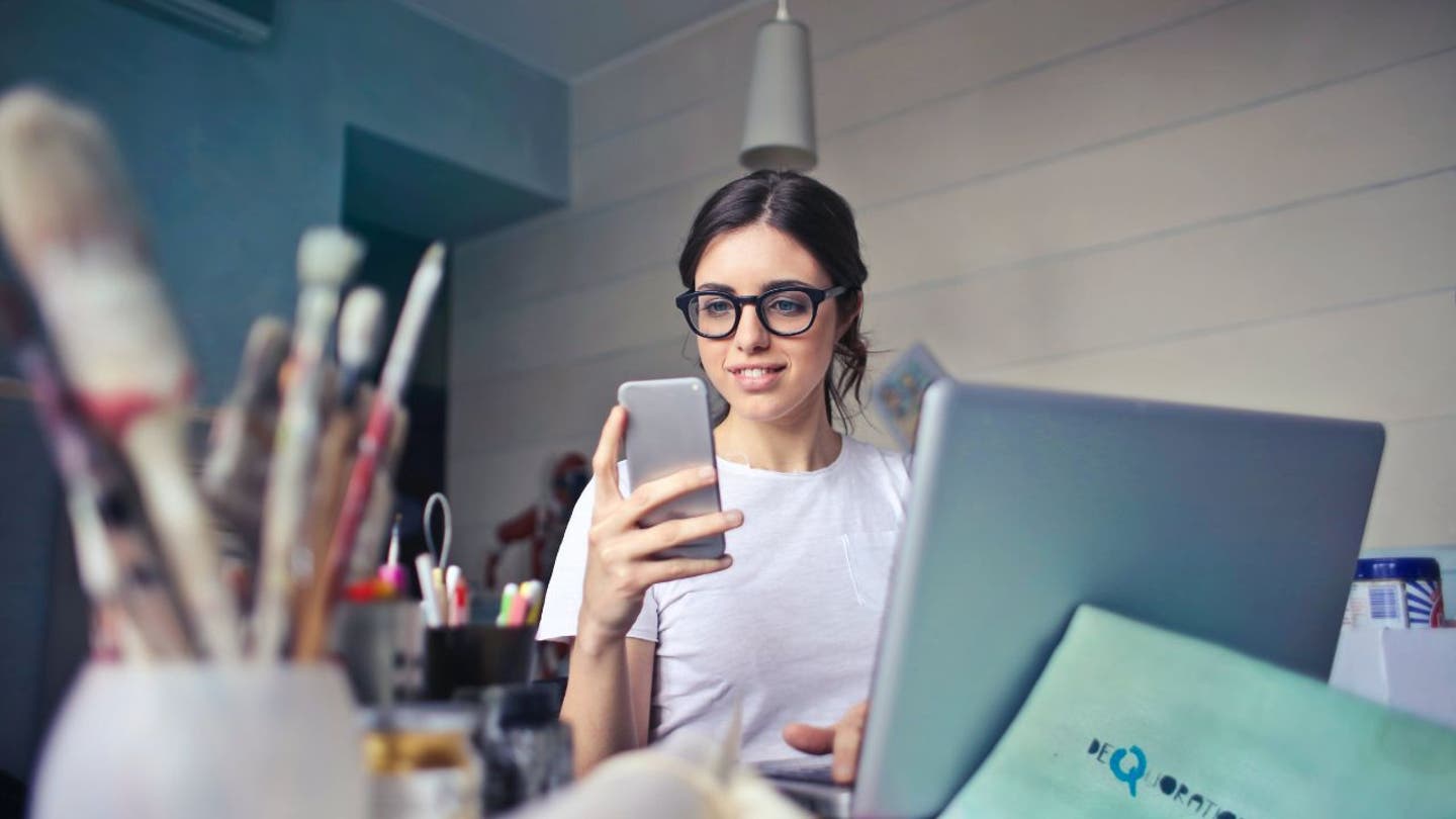 7 WOMAN SMILES AT PHONE