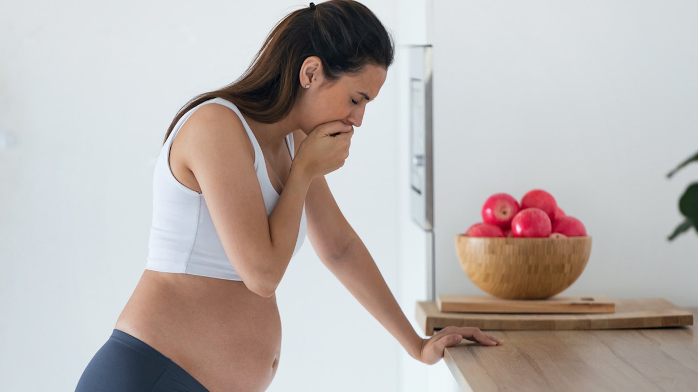 pregnant woman nausea standing