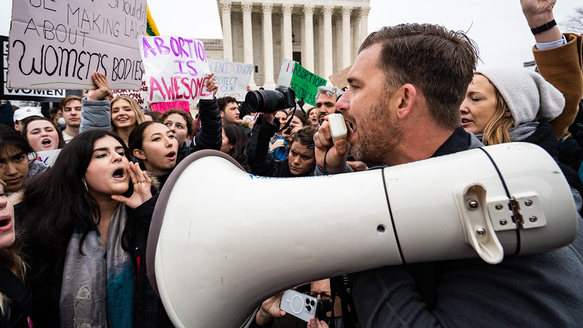 Abortion-rights and anti-abortion activists clash outside of the Supreme Court