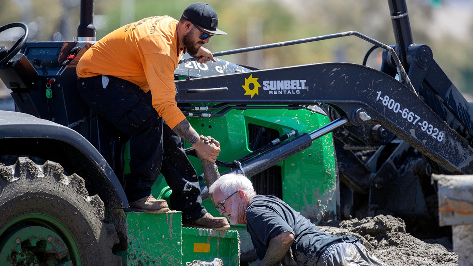 Adam Chastain pulls Ron Berlien out of mud