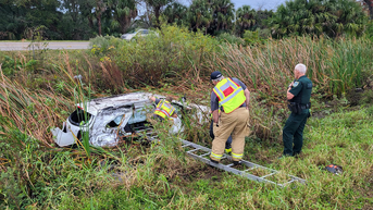 Florida deputies, firefighters form human chain to recover gifts after mother crashes car in watery ditch