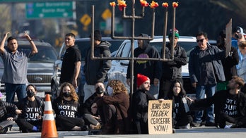 Angry commuters confront pro-Palestinian protesters blocking LA freeway during rush hour
