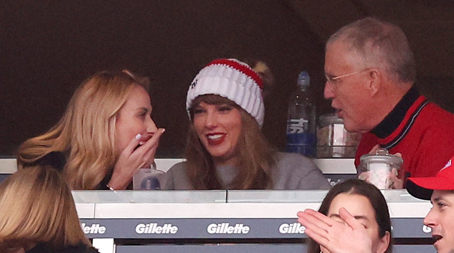 Taylor Swift cheers as she watches boyfriend Travis Kelce play football 