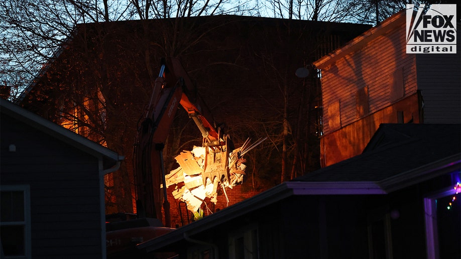 Construction vehicles demolishing the Idaho home.