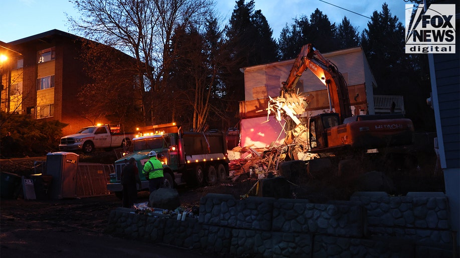 Construction vehicles demolishing the Idaho home.