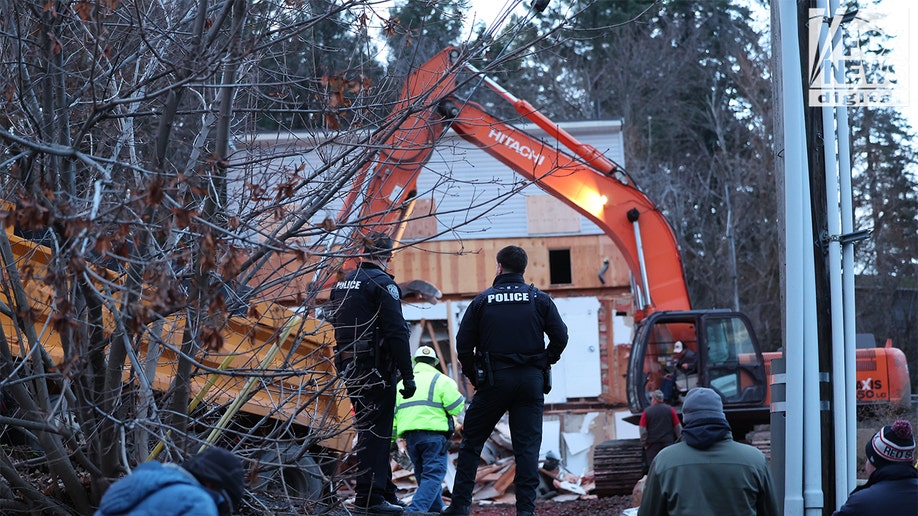 Construction vehicles demolishing the Idaho home.