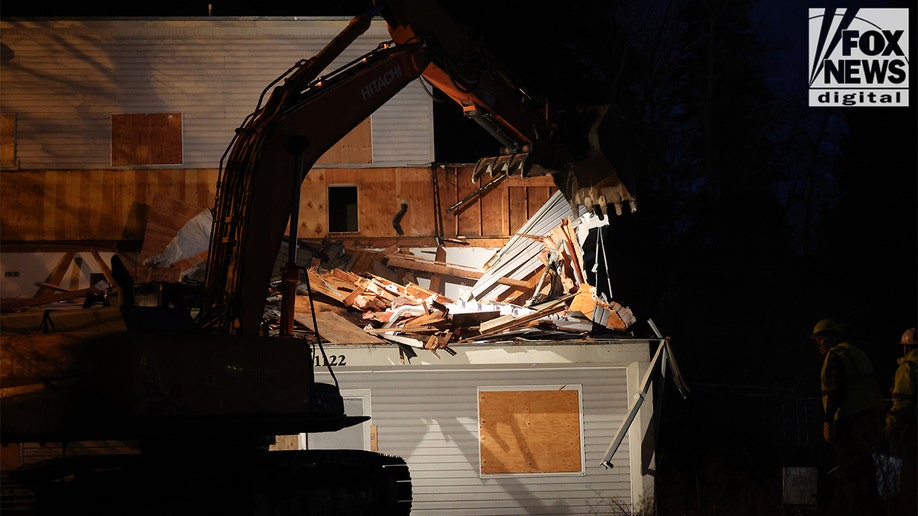 Construction vehicles demolishing the Idaho home.