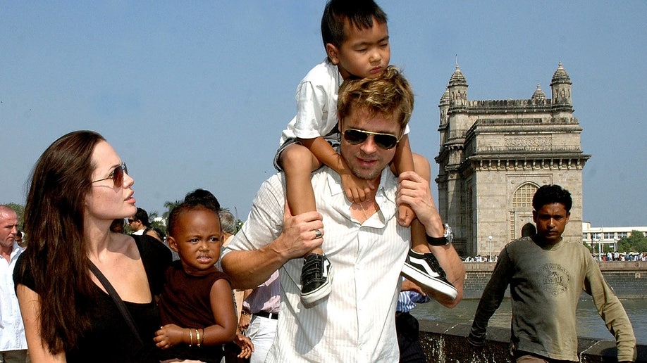 Brad Pitt holds his son Maddox