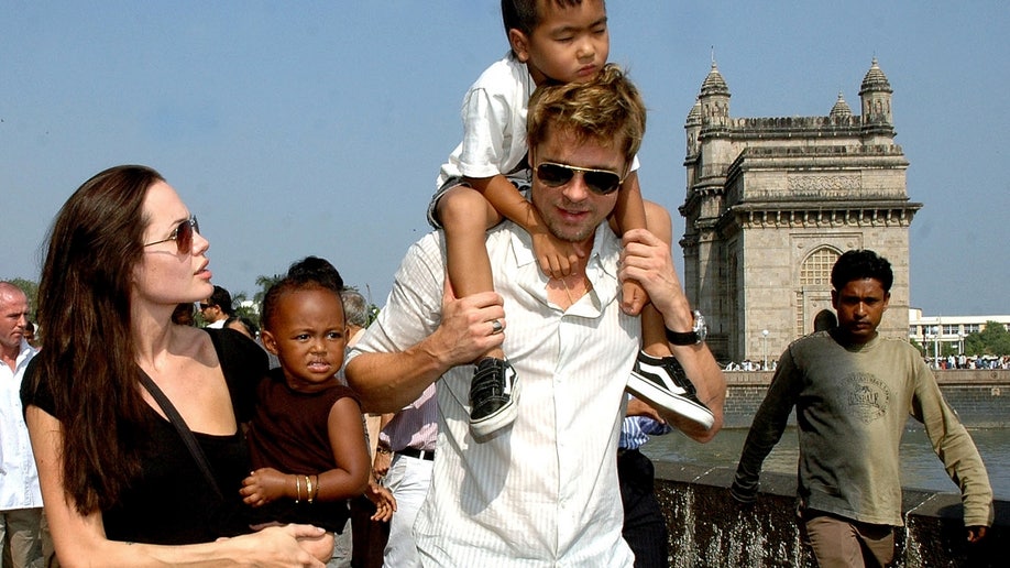 Brad Pitt holds his son Maddox