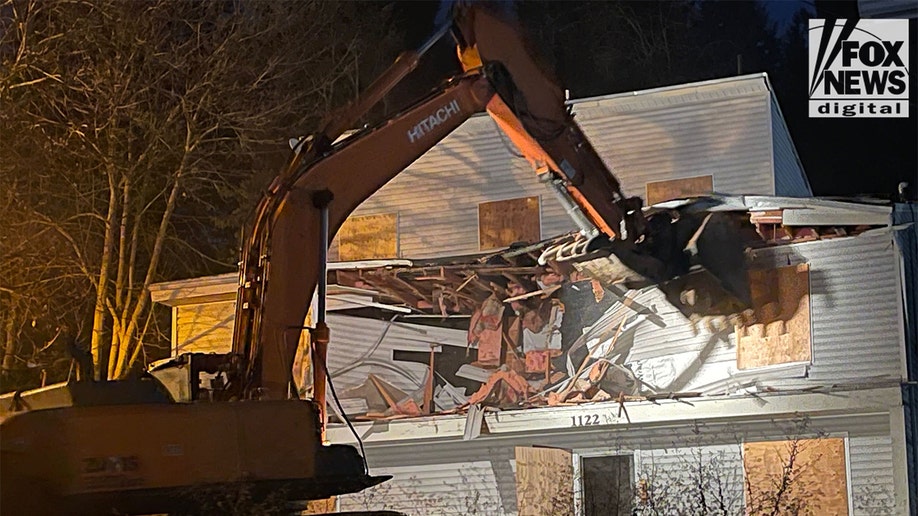 An excavator demolishes the King Road home in Moscow, Idaho