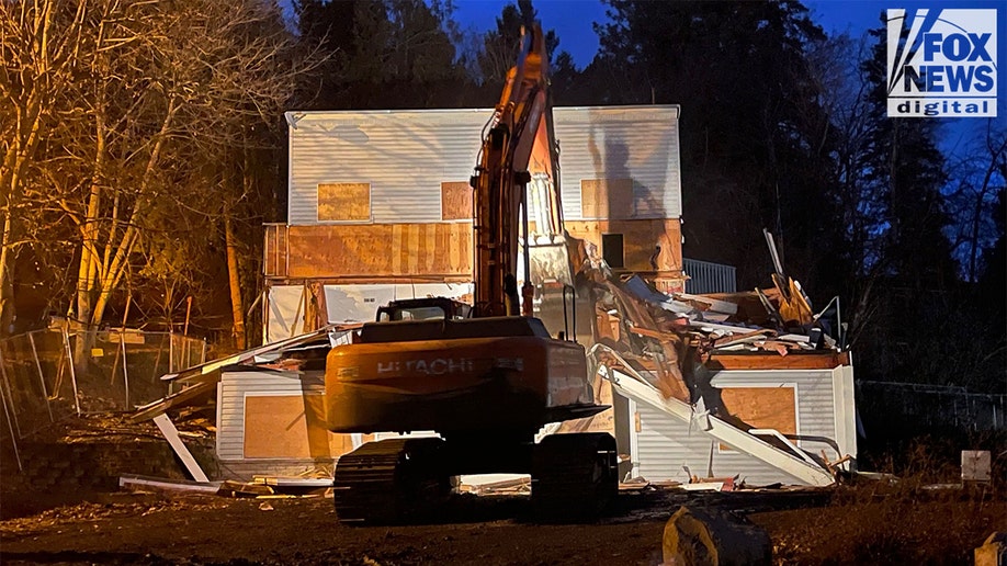 An excavator demolishes the King Road home in Moscow, Idaho