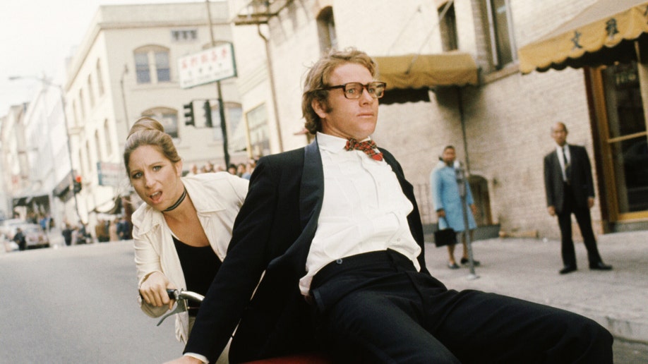 Ryan O'Neal and Barbra Streisand in a movie