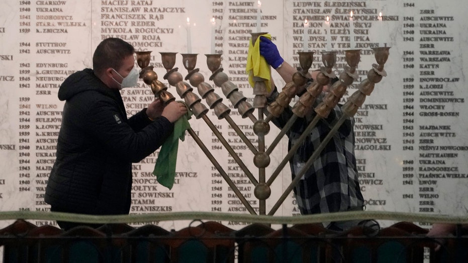 Far-right Polish lawmaker blasts menorah with fire extinguisher
