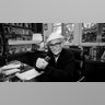 Norman Lear sits at a desk