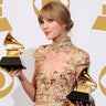 Taylor Swift poses with her Grammy awards.