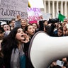 Abortion-rights and anti-abortion activists clash outside of the Supreme Court