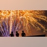 Visitors watch the fireworks during an Independence Day celebration
