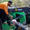 Adam Chastain pulls Ron Berlien out of mud